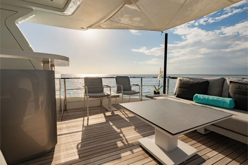 Slide: The Image of The 2024 Azimut Grande 36M features an elegant deck with modern furniture and ocean views. - 11