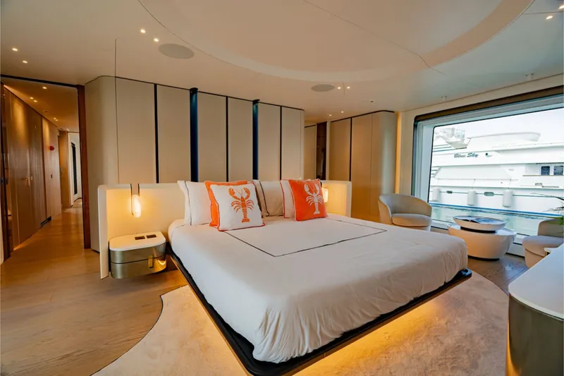 Slide: The Image of Luxurious bedroom with a large bed, modern furnishings, and large windows on a yacht. - 36