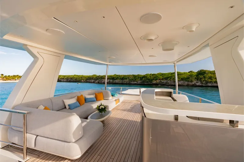 Slide: The Image of Luxurious flybridge of the Azimut Grande 36M with elegant sofas and bar, surrounded by scenic coastline. - 7