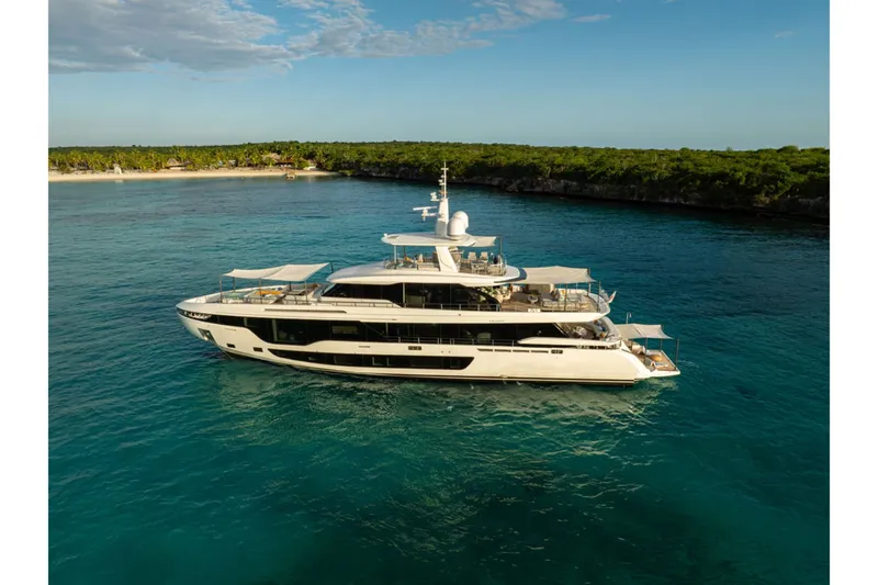Slide: The Image of The 2024 Azimut Grande 36M is a luxurious yacht anchored in clear, blue waters. - 3