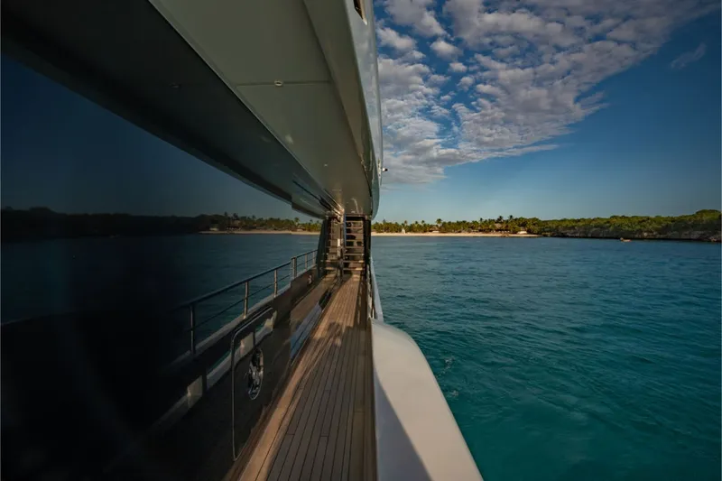 Slide: The Image of Side view of a luxury yacht on calm water with a cloudy sky. - 17