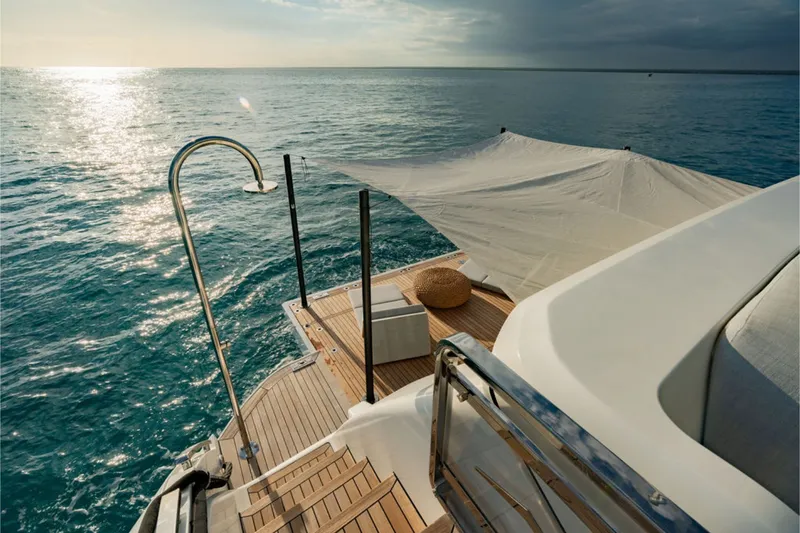 Slide: The Image of The 2024 Azimut Grande 36M features an elegant aft deck with a sunshade and ocean view. - 19