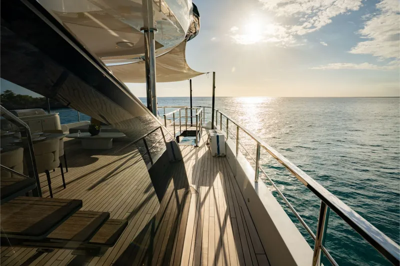 Slide: The Image of The 2024 Azimut Grande 36M features a sleek deck overlooking the sea at sunset. - 12
