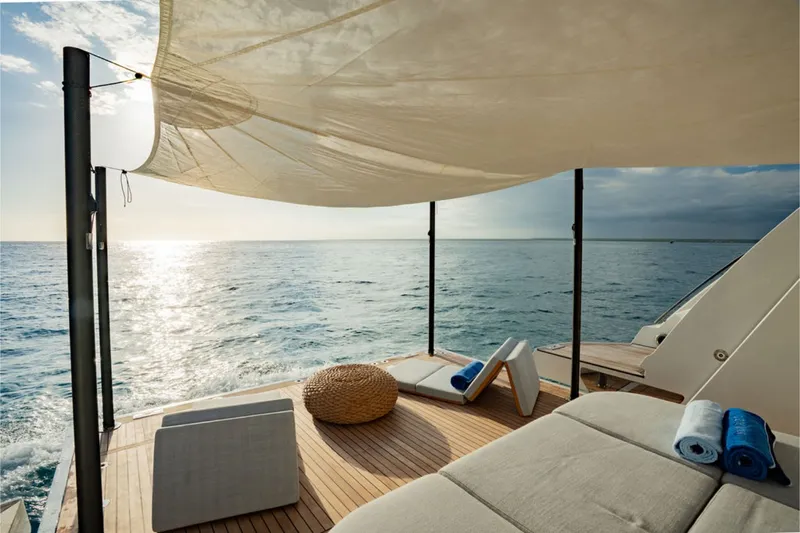 Slide: The Image of Luxurious deck of the Azimut Grande 36M with ocean view, sun loungers, and sunshade. - 14
