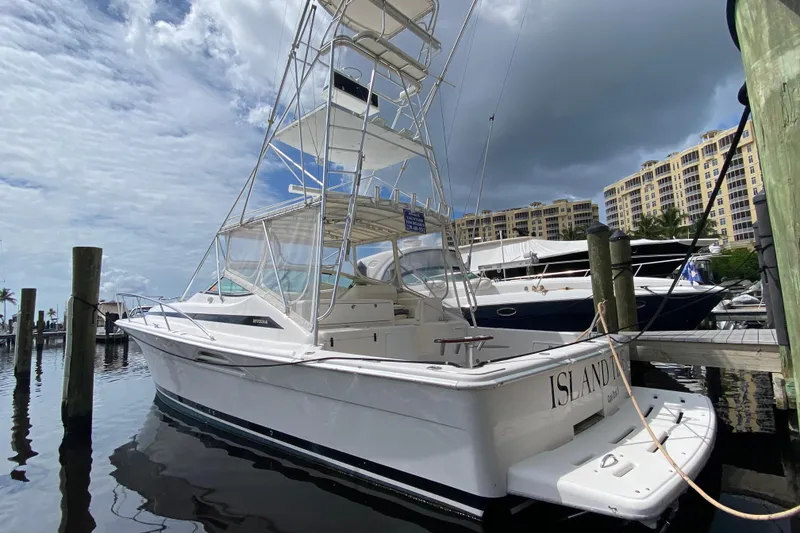The Image of Riviera 4000 yacht from 2000 docked at marina under cloudy sky. - 0