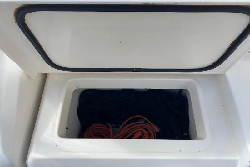 Slide: The Image of Open storage compartment on 2000 Riviera 4000 boat, containing coiled ropes. - 11
