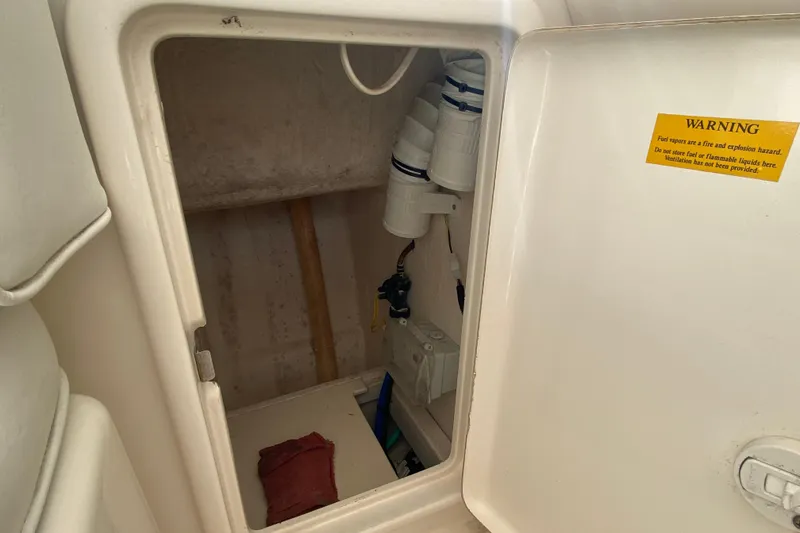 Slide: The Image of Riviera 4000 2000 model storage compartment with warning label and equipment inside. - 15