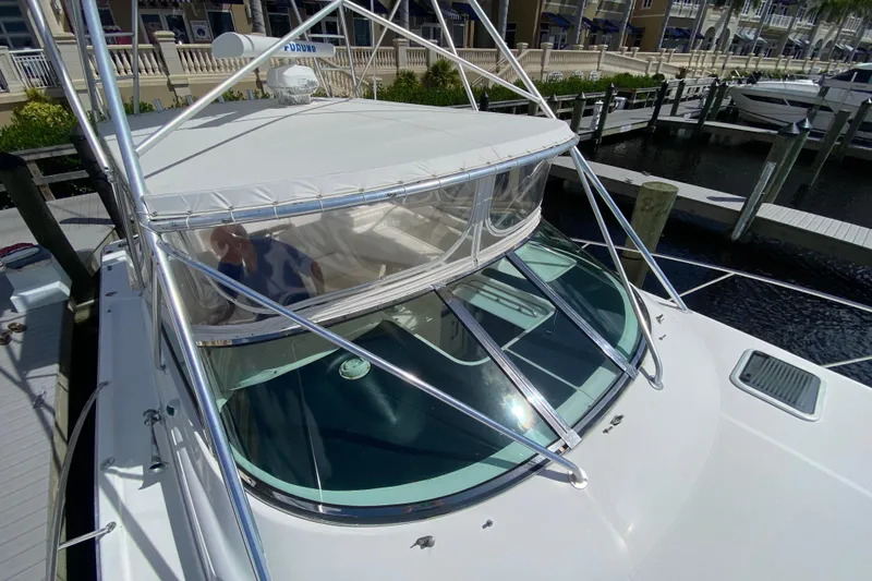 Slide: The Image of 2000 Riviera 4000 yacht docked at marina, featuring sleek design and spacious deck. - 18