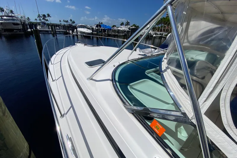 Slide: The Image of 2000 Riviera 4000 yacht docked at marina under clear blue sky. - 19
