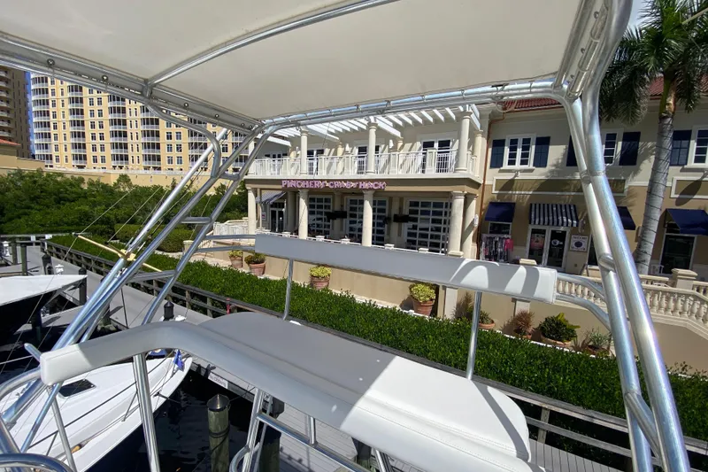 Slide: The Image of Riviera 4000 yacht docked near waterfront shops, sunny day, 2000 model. - 27