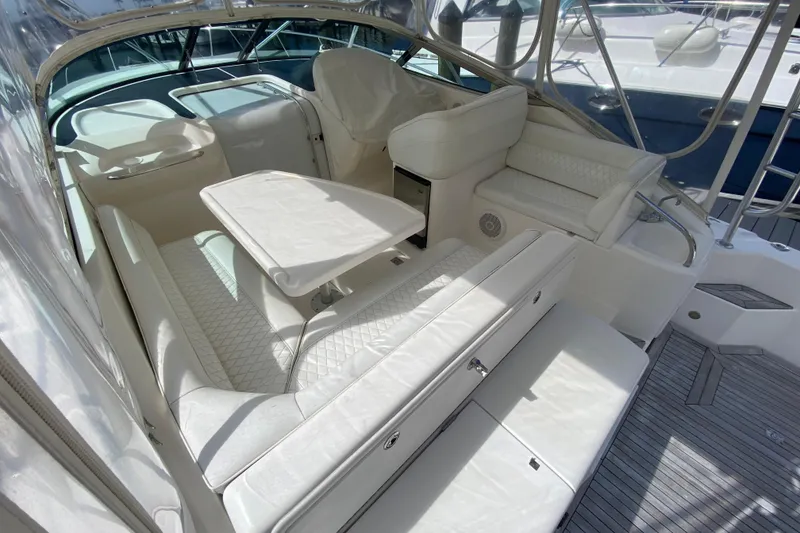 Slide: The Image of Luxurious interior of 2000 Riviera 4000 yacht with white seating and table. - 28
