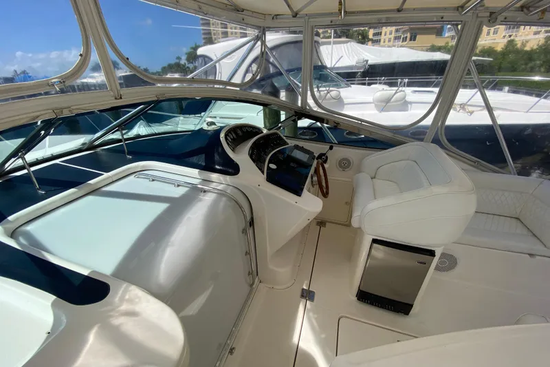 Slide: The Image of Cockpit of 2000 Riviera 4000 yacht with white seating and modern controls. - 29
