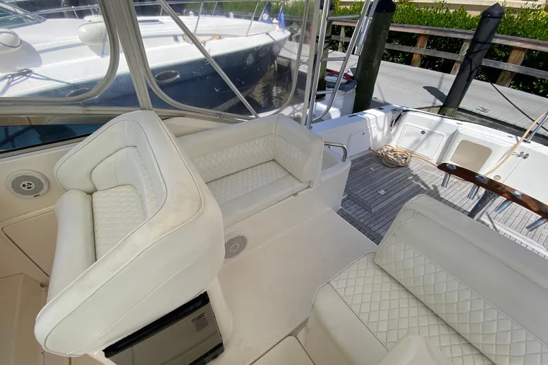 Slide: The Image of Luxurious 2000 Riviera 4000 yacht interior with white leather seating and teak flooring. - 32