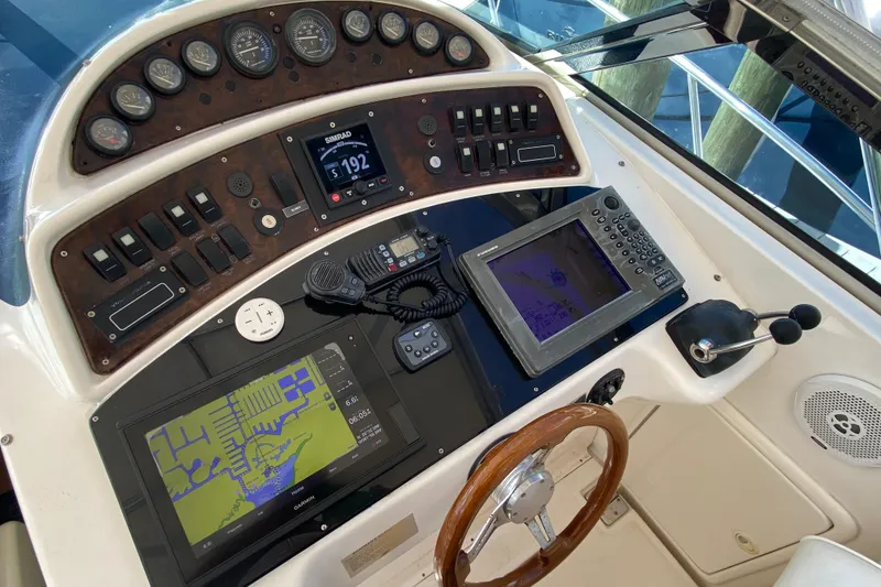 Slide: The Image of Control panel of a 2000 Riviera 4000 boat with navigation equipment and steering wheel. - 37