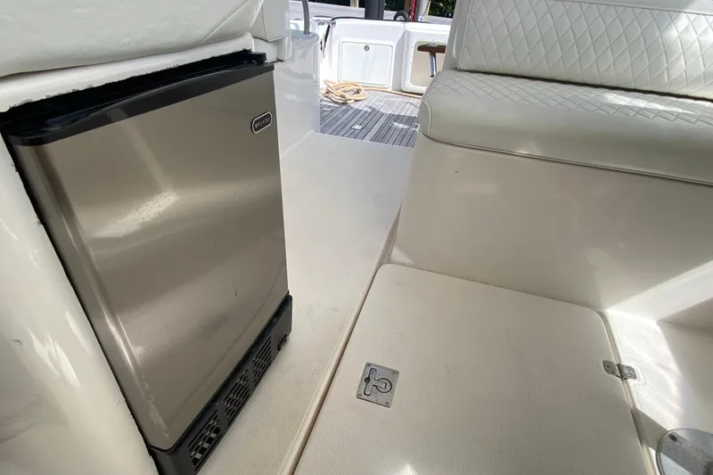 Slide: The Image of Interior of 2000 Riviera 4000 yacht with mini fridge and cushioned seating. - 40