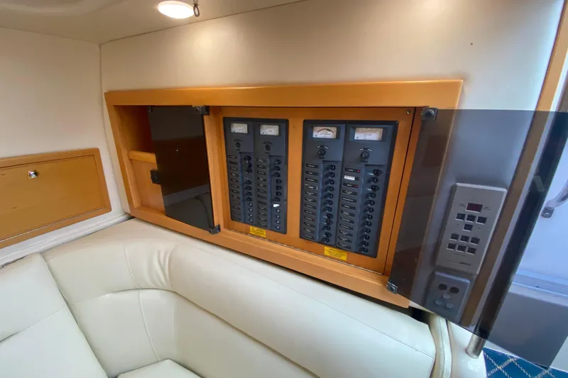 Slide: The Image of Electrical panel inside 2000 Riviera 4000 yacht, featuring control switches and meters. - 44