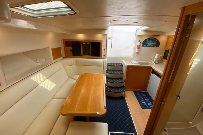 Slide: The Image of Interior of 2000 Riviera 4000 yacht with cozy seating and kitchenette. - 47