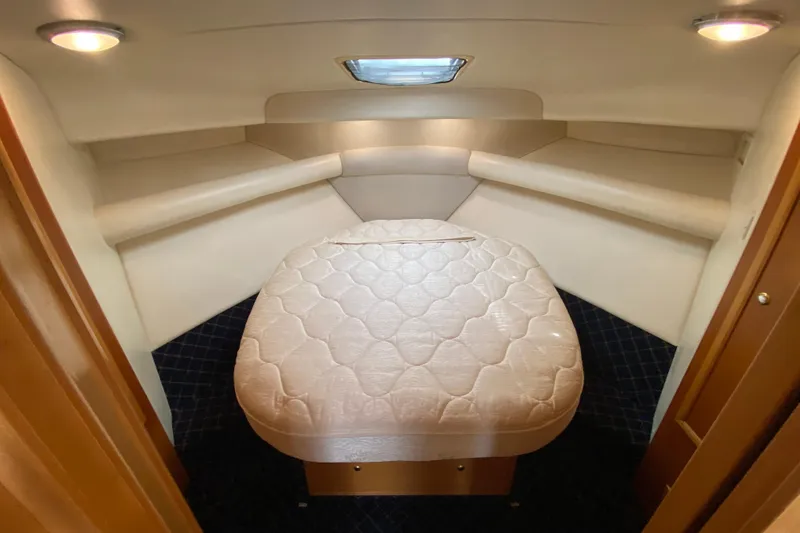Slide: The Image of Interior cabin of 2000 Riviera 4000 yacht with cozy bed and ambient lighting. - 49