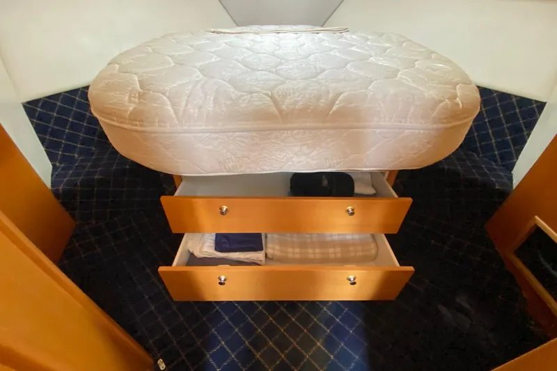 Slide: The Image of Under-bed storage drawers in a 2000 Riviera 4000 yacht cabin. - 50