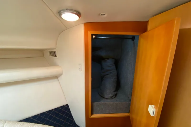 Slide: The Image of Interior cabin of 2000 Riviera 4000 yacht with open wooden closet. - 52
