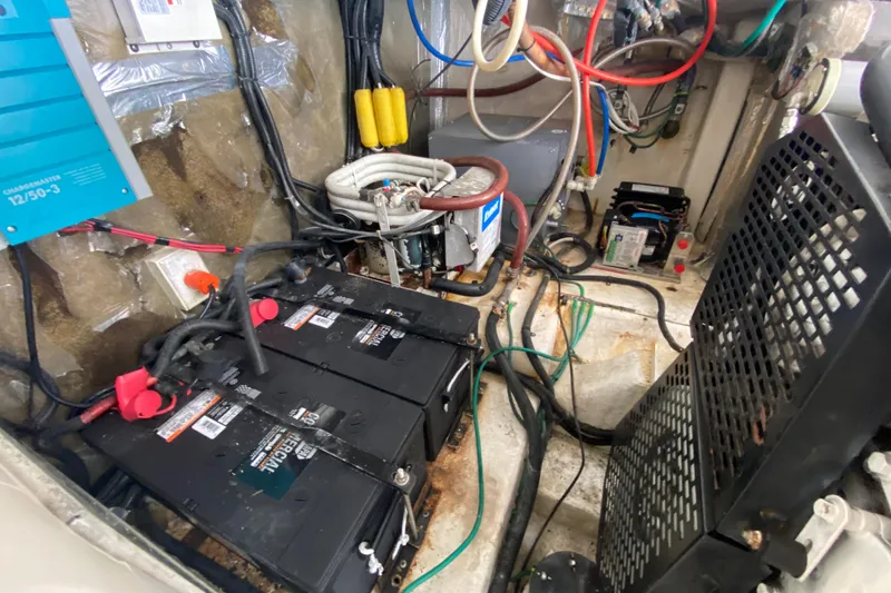 Slide: The Image of Engine room of 2000 Riviera 4000 with batteries and wiring system. - 59