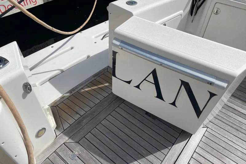 Slide: The Image of Riviera 4000 yacht deck with partial name visible, featuring wooden flooring, 2000 model. - 6