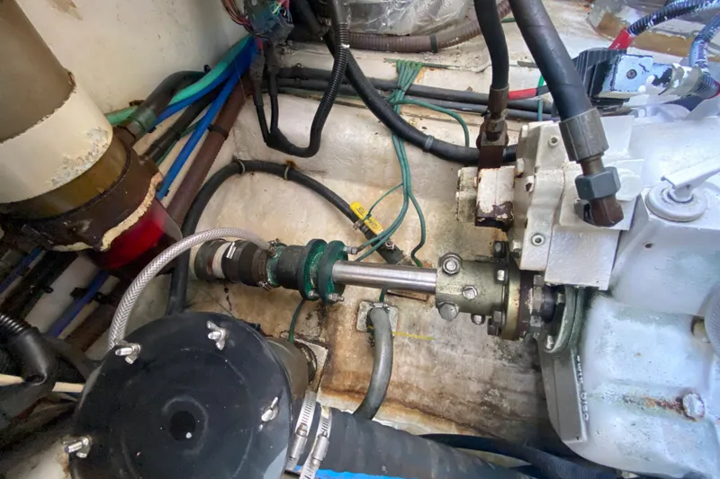 Slide: The Image of Engine compartment of a 2000 Riviera 4000 boat, showing mechanical components and wiring. - 61