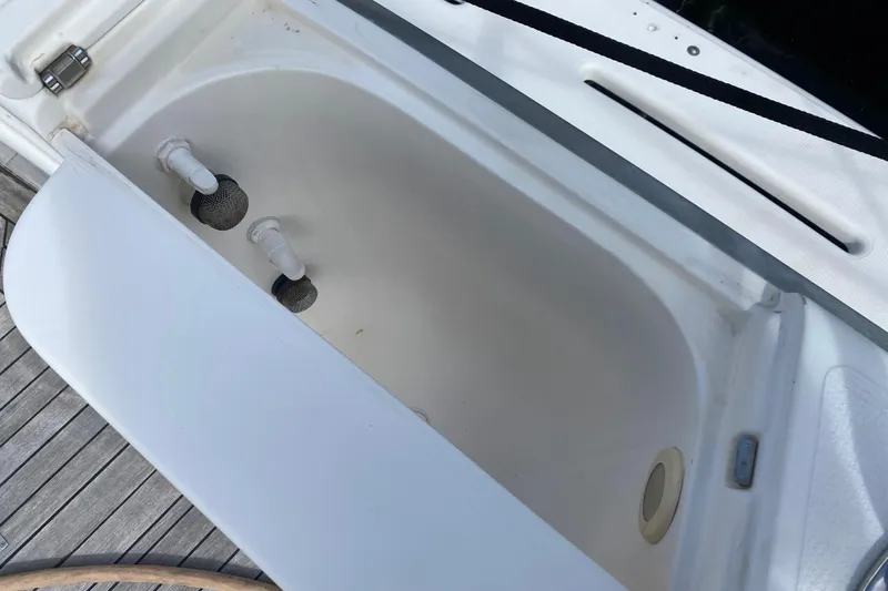 Slide: The Image of Open storage compartment on 2000 Riviera 4000 boat, featuring white interior and fittings. - 9