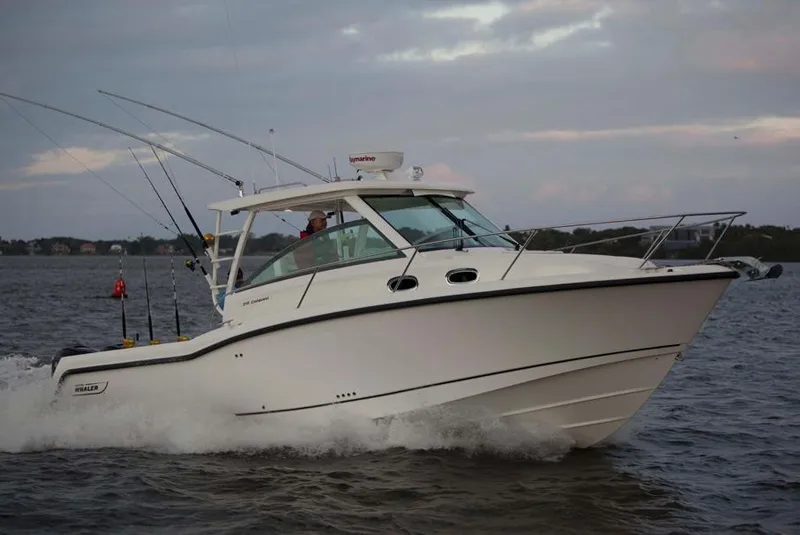 Slide: The Image of Manufacturer Provided Image: 2015 Boston Whaler 315 Conquest cruising on the water at sunset. - 12