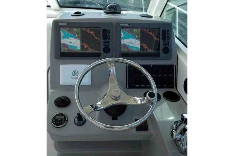 Slide: The Image of Manufacturer Provided Image: Boston Whaler 315 Conquest 2015 helm with dual navigation screens and steering wheel. - 7