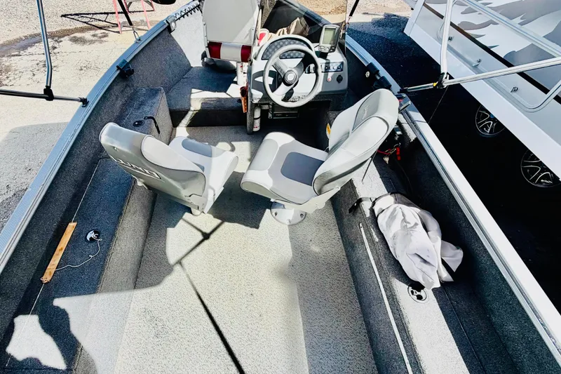 Slide: The Image of 2006 Lund 1625 Classic SS boat interior with steering wheel and seating. - 7