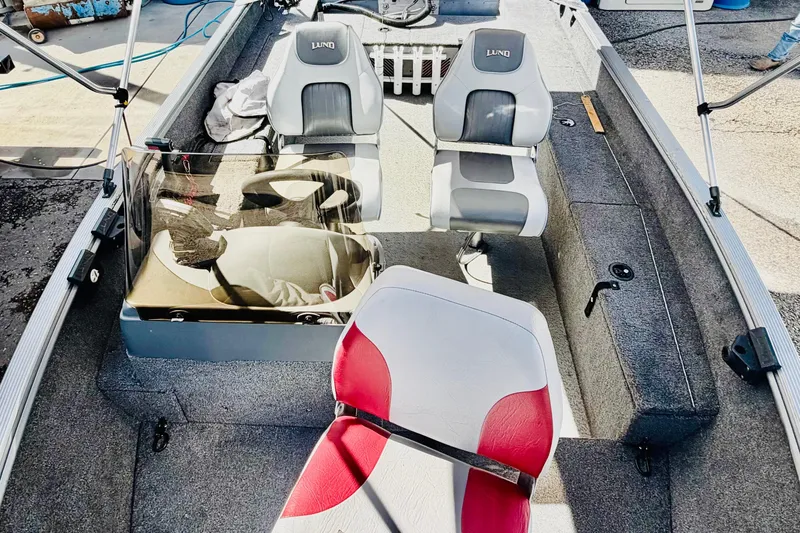 Slide: The Image of 2006 Lund 1625 Classic SS boat interior with seating and steering console. - 9