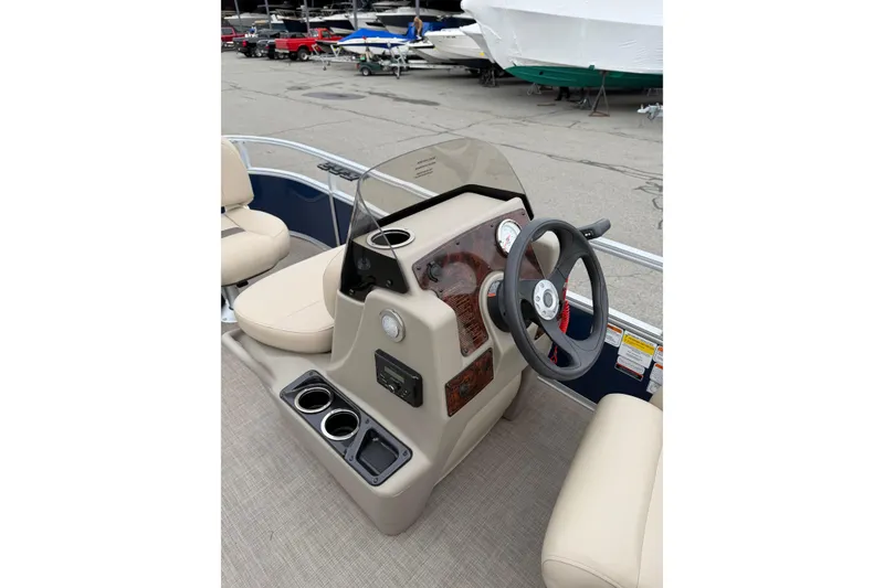 Slide: The Image of 2022 Sun Tracker Bass Buggy 16 XL boat console with steering wheel and seating. - 6