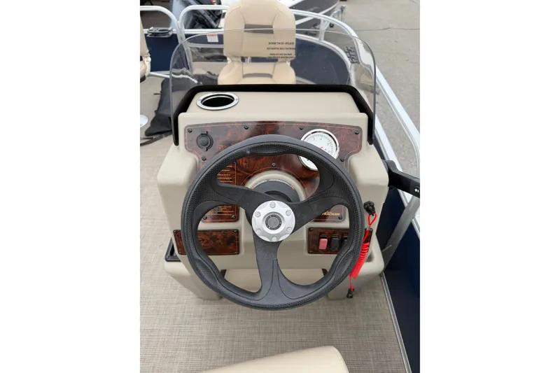 Slide: The Image of 2022 Sun Tracker Bass Buggy 16 XL steering console with gauges and controls. - 7