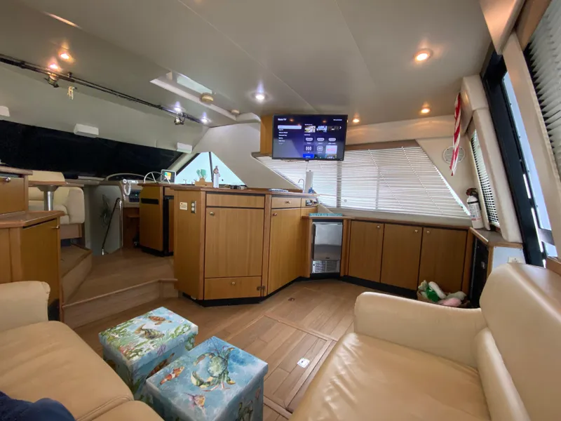 Slide: The Image of Interior of 2001 Bayliner 3988 yacht with modern furnishings and entertainment system. - 10