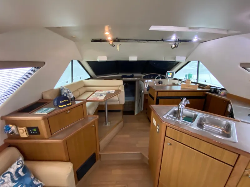 Slide: The Image of Interior of 2001 Bayliner 3988 yacht with kitchen and seating area. - 11