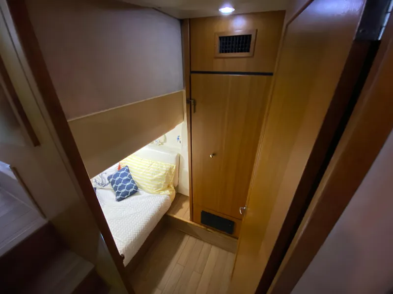 Slide: The Image of Cozy cabin interior of 2001 Bayliner 3988 yacht with bed and wooden furnishings. - 20