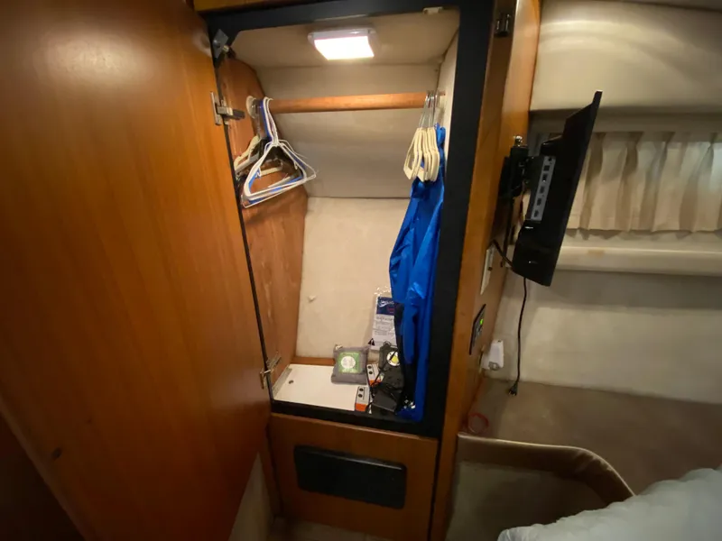 Slide: The Image of Closet interior of 2001 Bayliner 3988 yacht with hangers and clothing. - 30