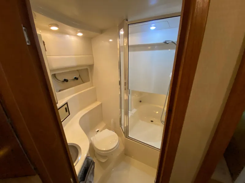 Slide: The Image of Bathroom interior of 2001 Bayliner 3988 yacht, featuring shower and toilet. - 32