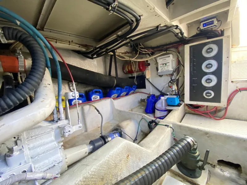 Slide: The Image of Engine room of 2001 Bayliner 3988, showing equipment, wiring, and maintenance supplies. - 39