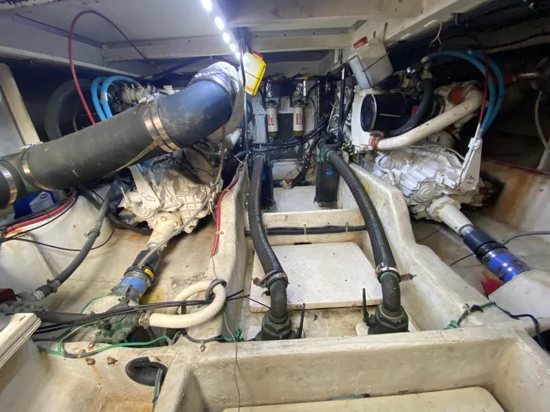 Slide: The Image of Engine room of a 2001 Bayliner 3988 boat, showcasing mechanical components and piping. - 41