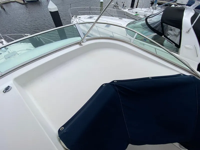 Slide: The Image of 2001 Bayliner 3988 yacht deck with blue cover, docked at marina. - 46