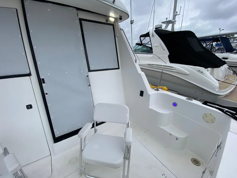 Slide: The Image of 2001 Bayliner 3988 boat deck with seating, docked at marina. - 5
