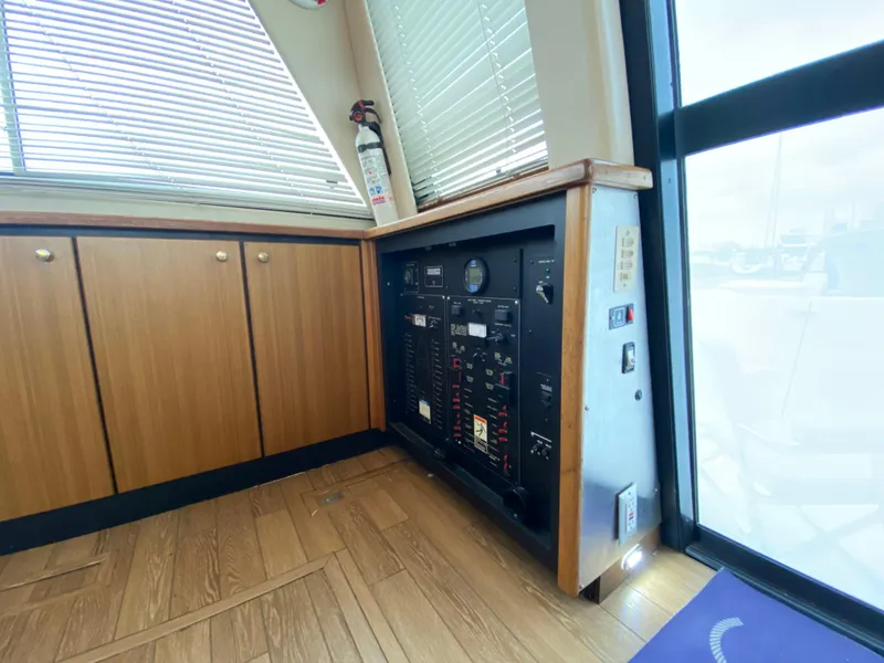 Slide: The Image of 2001 Bayliner 3988 interior with control panel and wooden cabinetry. - 8