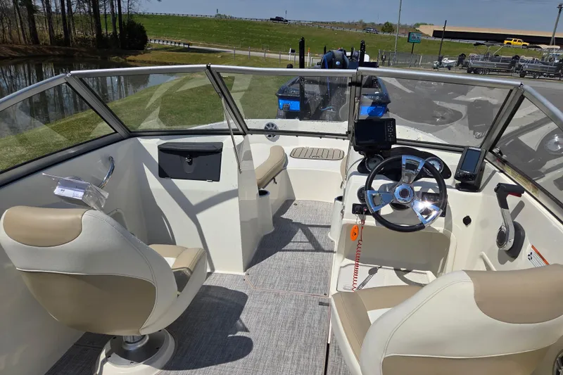 Slide: The Image of 2017 Stingray 191 DC boat interior with steering wheel and seating. - 10