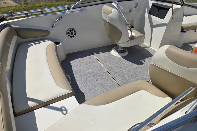 Slide: The Image of Interior of a 2017 Stingray 191 DC boat with beige and white seating. - 11