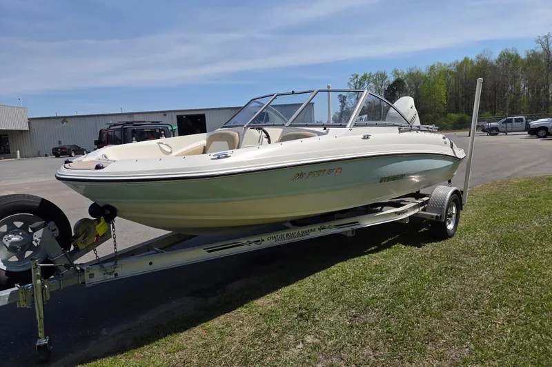 Slide: The Image of 2017 Stingray 191 DC boat on trailer, parked outdoors on grass. - 7