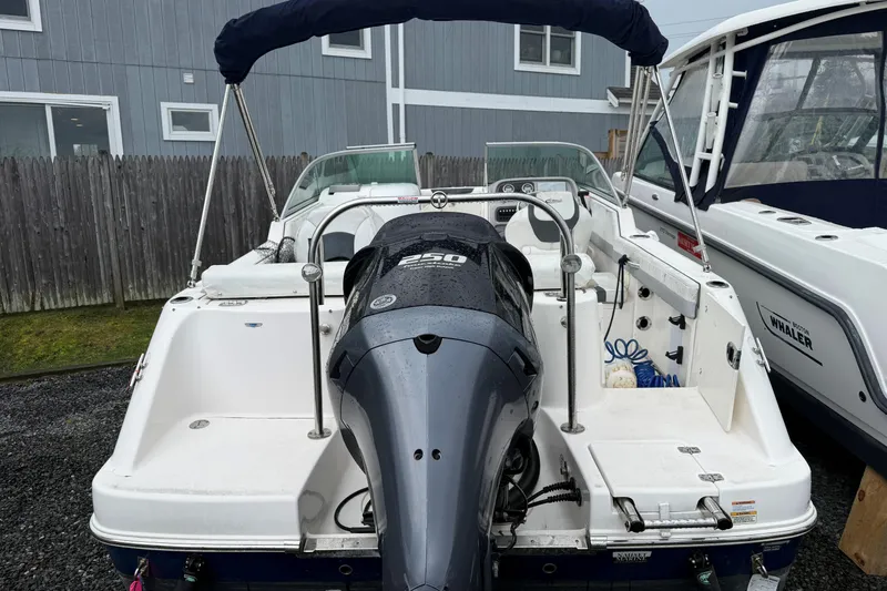 Slide: The Image of 2021 Robalo R227 Dual Console boat with Yamaha outboard motor, docked outdoors. - 10