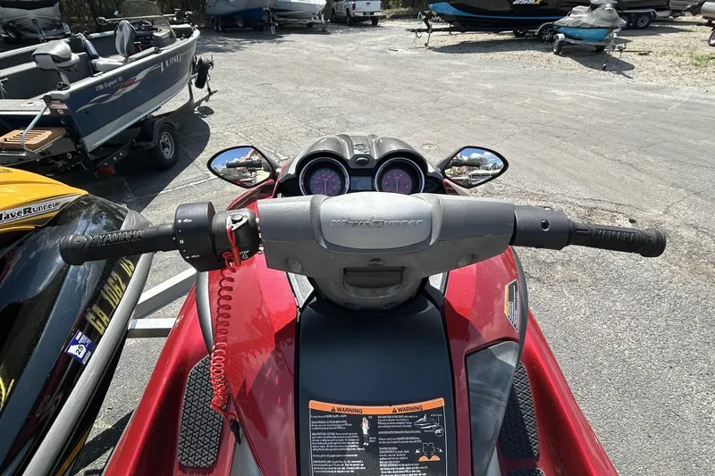 Slide: The Image of 2011 Yamaha WaveRunner FZS handlebars and dashboard, parked among boats. - 8