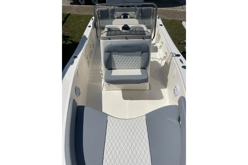 Slide: The Image of 2026 Pioneer 180 Islander boat interior with cushioned seating and steering console. - 5